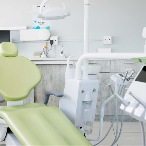 a dental room with a green chair