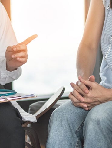 Patient couple consulting with doctor or psychologist on marriage counseling, family medical healthcare therapy, In vitro fertility IVF treatment for infertility, or psychotherapy session concept