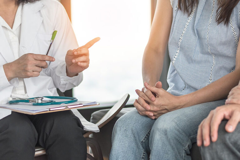 Patient couple consulting with doctor or psychologist on marriage counseling, family medical healthcare therapy, In vitro fertility IVF treatment for infertility, or psychotherapy session concept