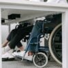 Photo by Ivan S: https://www.pexels.com/photo/person-in-blue-denim-jeans-sitting-on-blue-and-black-wheelchair-8127701/