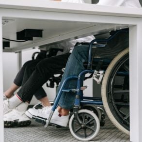 Photo by Ivan S: https://www.pexels.com/photo/person-in-blue-denim-jeans-sitting-on-blue-and-black-wheelchair-8127701/