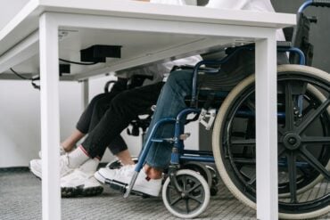 Photo by Ivan S: https://www.pexels.com/photo/person-in-blue-denim-jeans-sitting-on-blue-and-black-wheelchair-8127701/