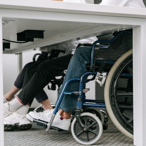 Photo by Ivan S: https://www.pexels.com/photo/person-in-blue-denim-jeans-sitting-on-blue-and-black-wheelchair-8127701/