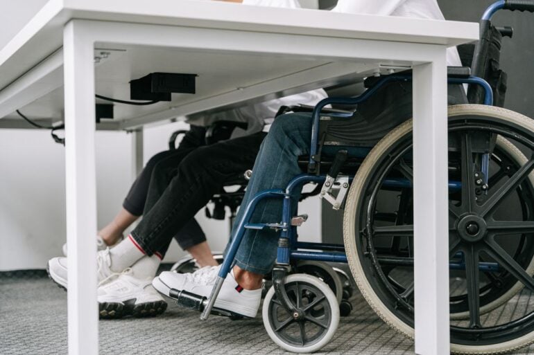 Photo by Ivan S: https://www.pexels.com/photo/person-in-blue-denim-jeans-sitting-on-blue-and-black-wheelchair-8127701/